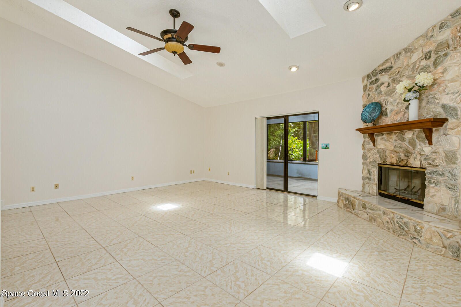 4650 Corey Road Grant Valkaria, FL 32950 - Photo 11 of 56 an empty room with windows and fireplace