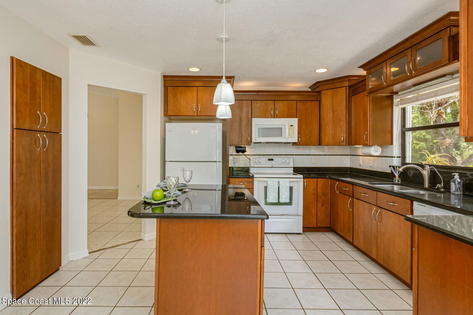 4650 Corey Road Grant Valkaria, FL 32950 - Photo 13 of 56 a kitchen with stainless steel appliances granite countertop a refrigerator a sink and a stove