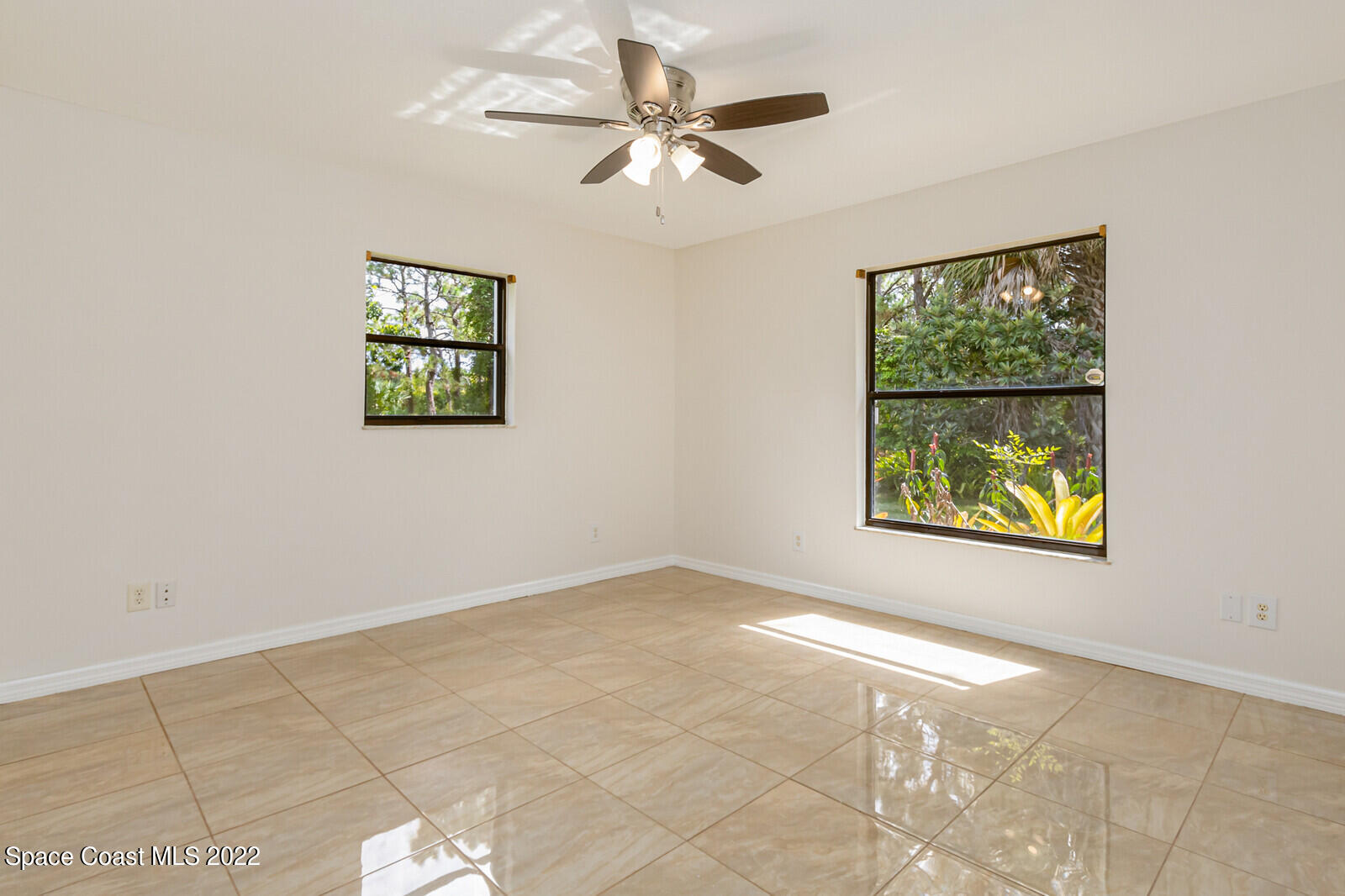 4650 Corey Road Grant Valkaria, FL 32950 - Photo 25 of 56 an empty room with windows and fan