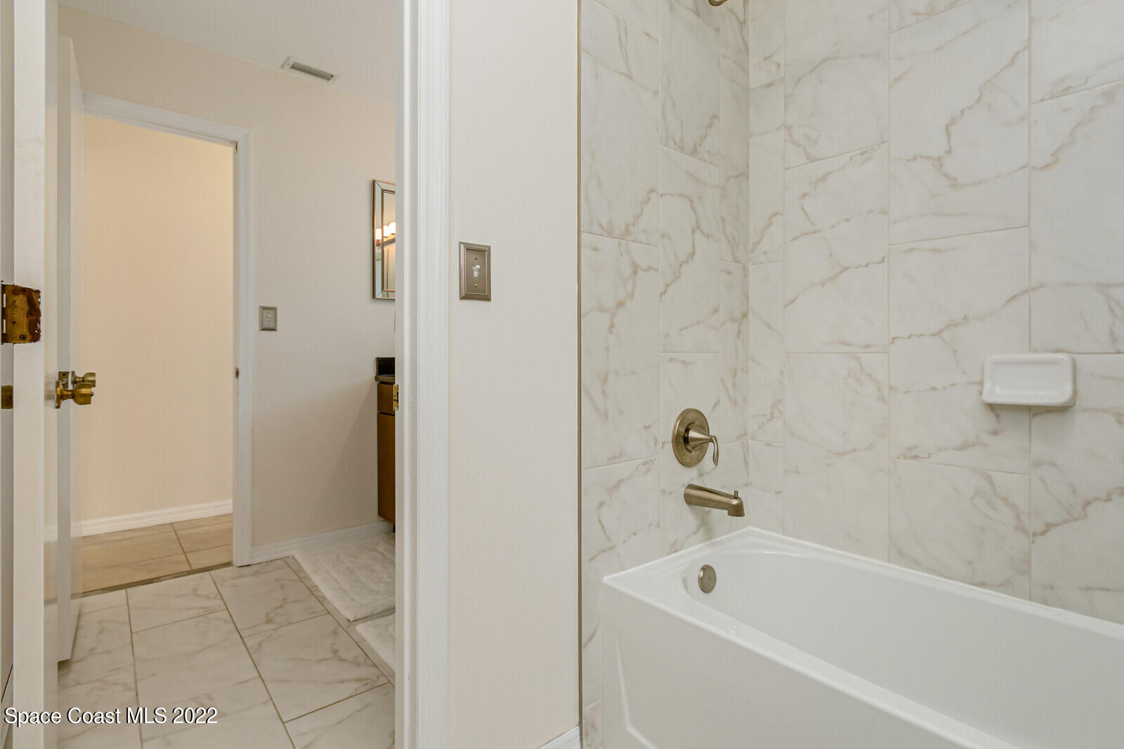 4650 Corey Road Grant Valkaria, FL 32950 - Photo 27 of 56 a bathroom with a tub