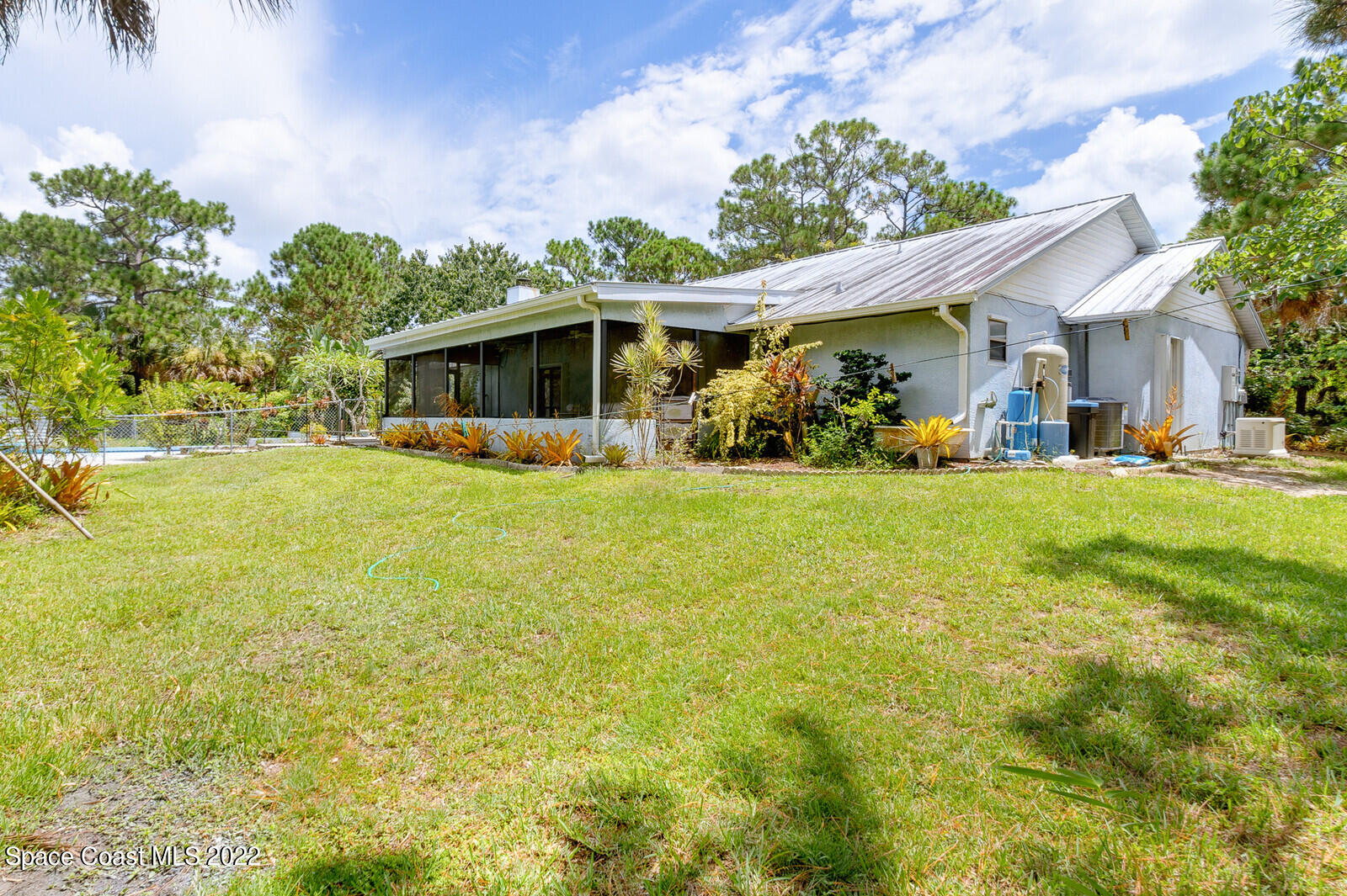 4650 Corey Road Grant Valkaria, FL 32950 - Photo 35 of 56 a view of a house with a big yard and potted plants