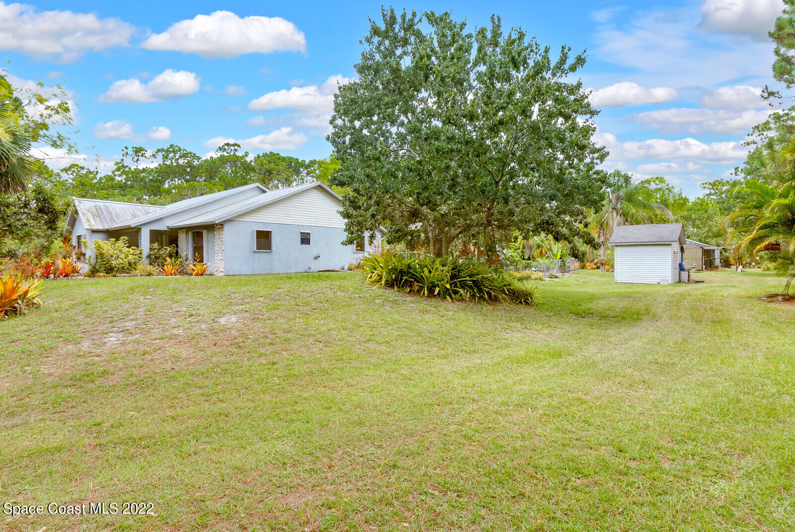 4650 Corey Road Grant Valkaria, FL 32950 - Photo 37 of 56 a front view of a house with a garden
