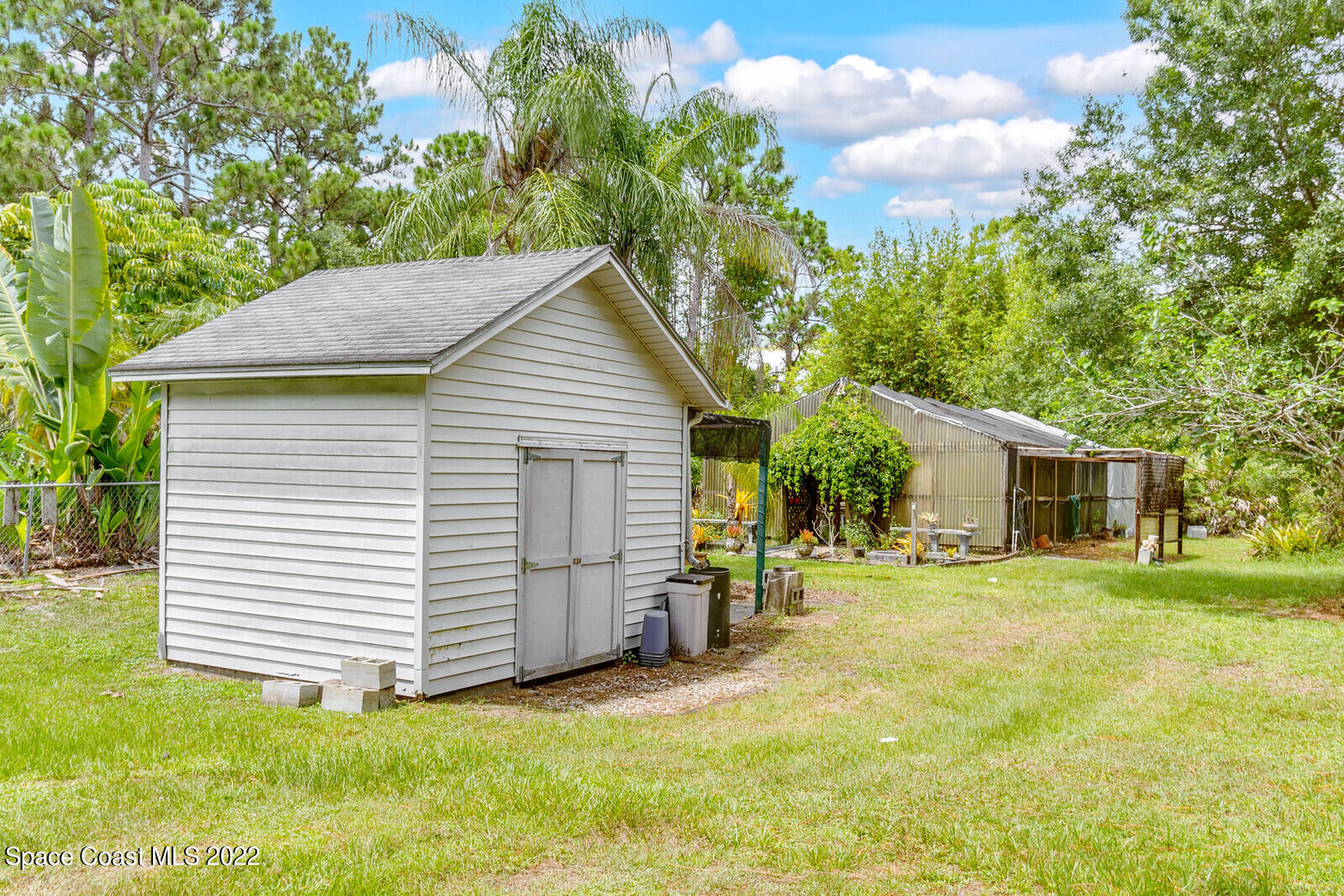4650 Corey Road Grant Valkaria, FL 32950 - Photo 38 of 56 a view of a house with a yard