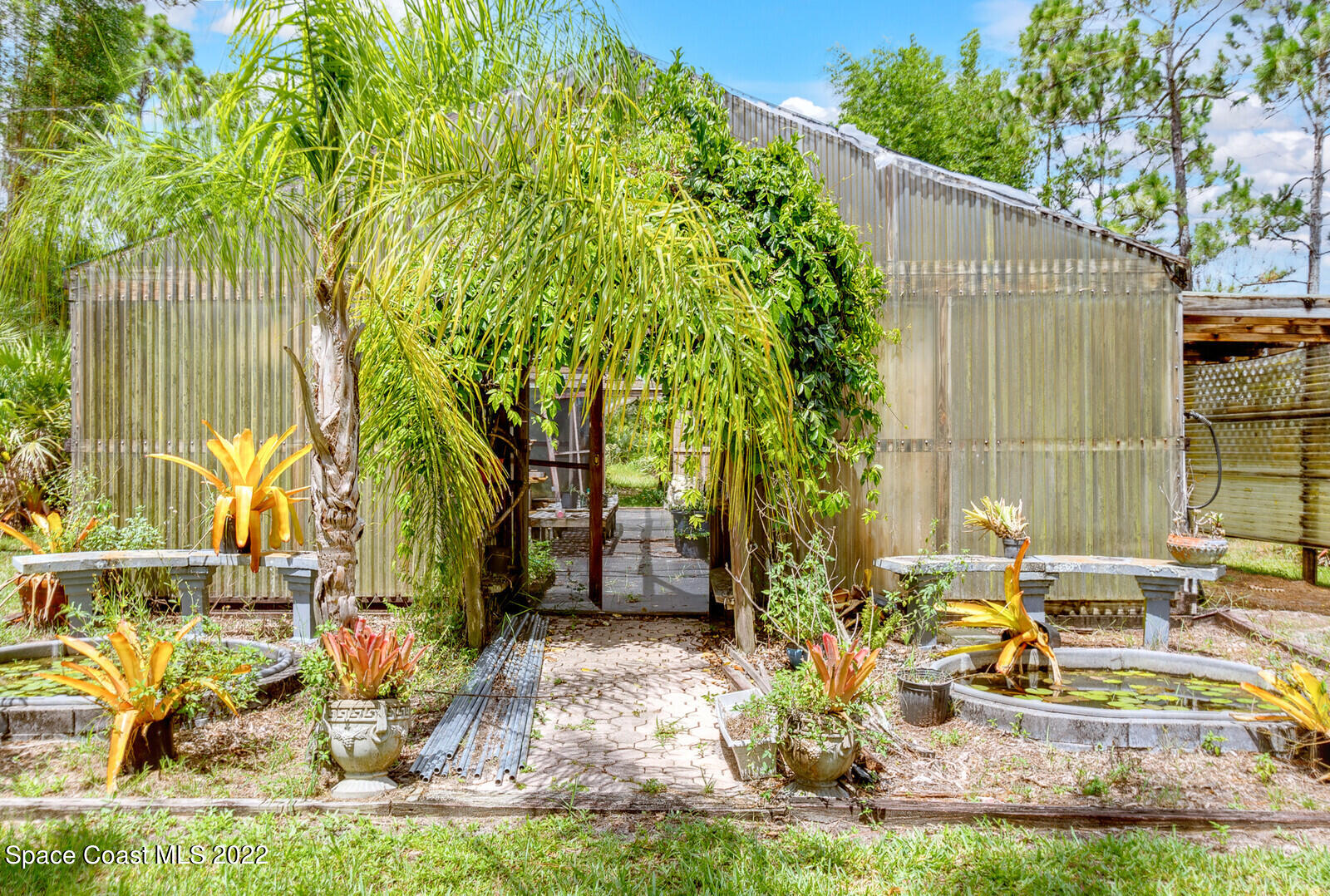 4650 Corey Road Grant Valkaria, FL 32950 - Photo 40 of 56 a view of backyard of house with outdoor seating