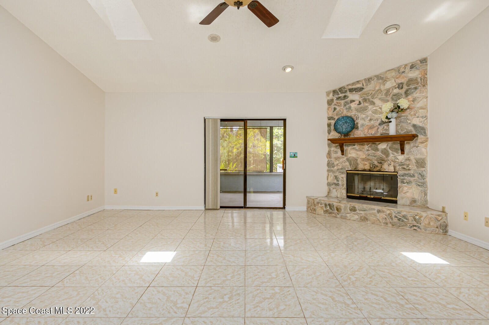 4650 Corey Road Grant Valkaria, FL 32950 - Photo 4 of 56 an empty room with windows and fireplace