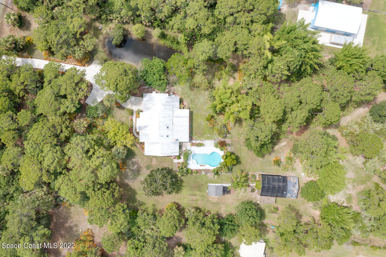 4650 Corey Road Grant Valkaria, FL 32950 - Photo 44 of 56 an aerial view of residential house with outdoor space and trees all around