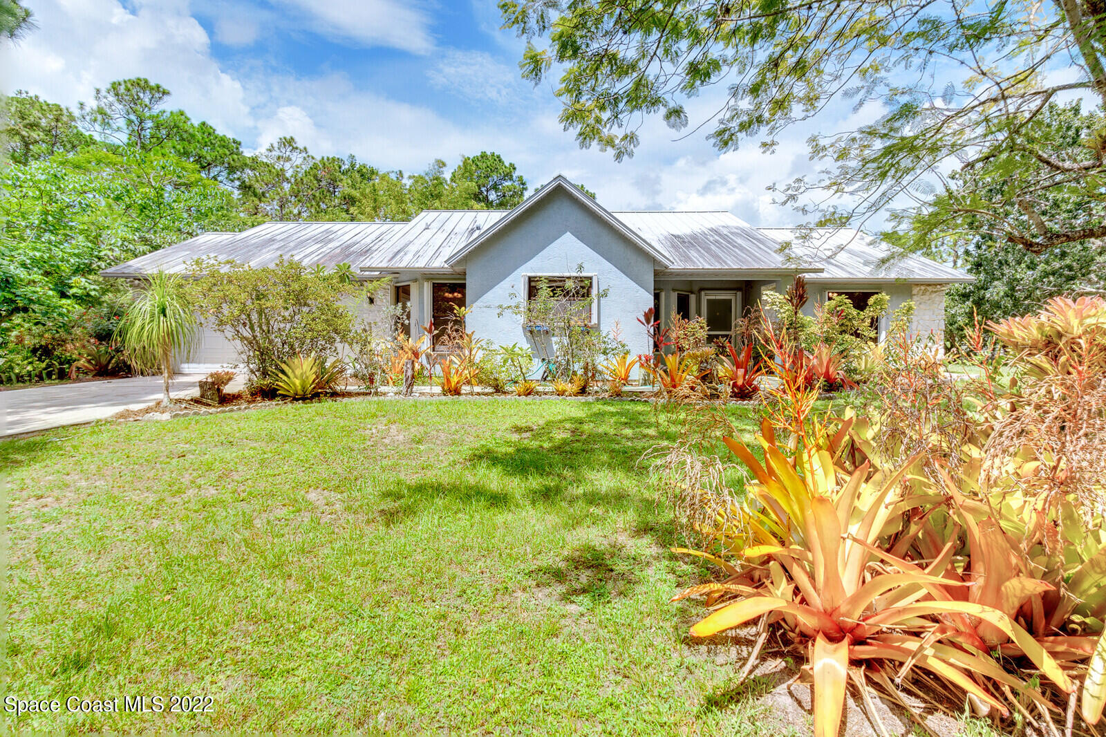 4650 Corey Road Grant Valkaria, FL 32950 - Photo 45 of 56 a front view of a house with garden