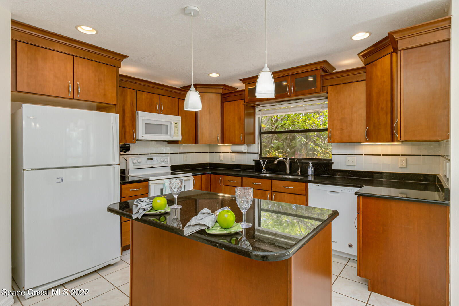 4650 Corey Road Grant Valkaria, FL 32950 - Photo 5 of 56 a kitchen with stainless steel appliances granite countertop a refrigerator a stove and a sink with wooden floor