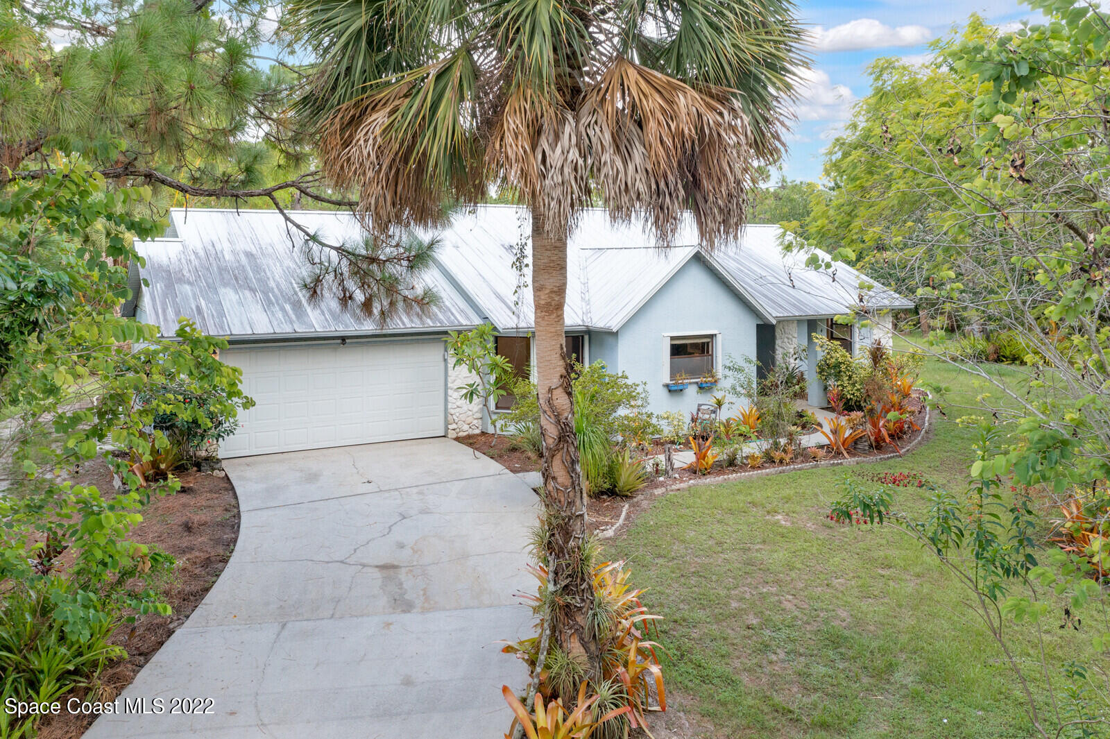 4650 Corey Road Grant Valkaria, FL 32950 - Photo 51 of 56 a house with a tree in front of it