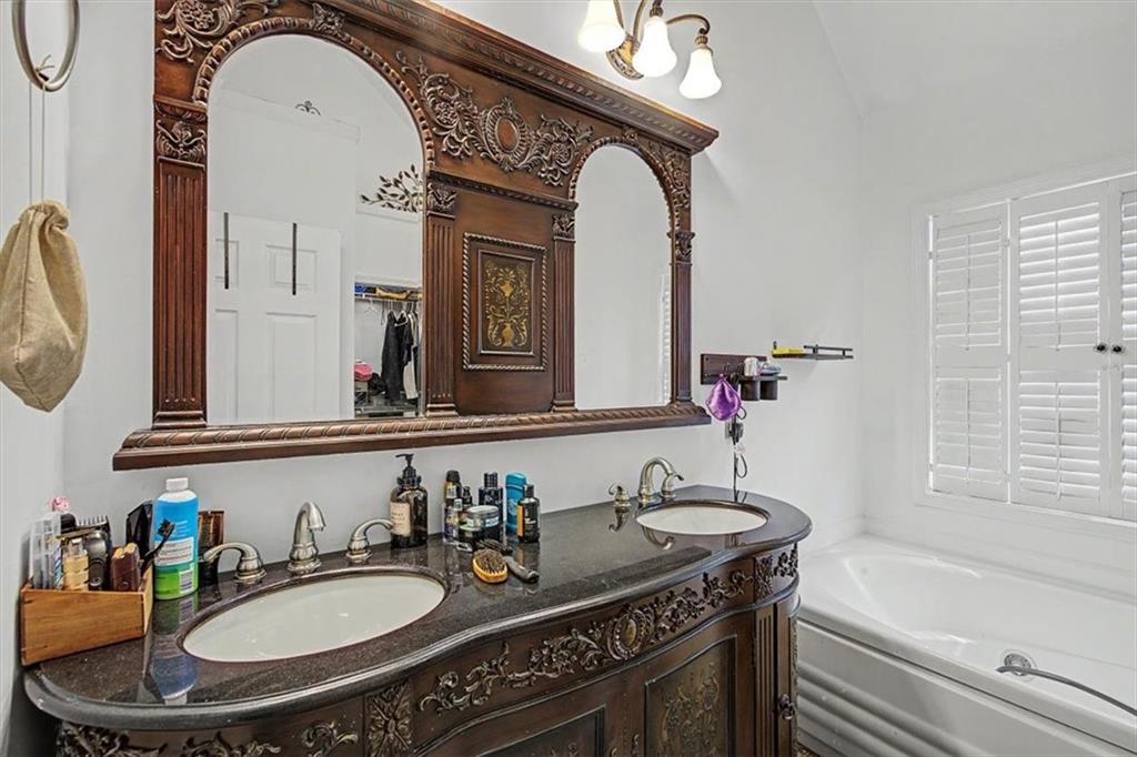 409 Windsor Way Canton, GA 30115 - Photo 17 of 51 a bathroom with a granite countertop sink a mirror and a bathtub