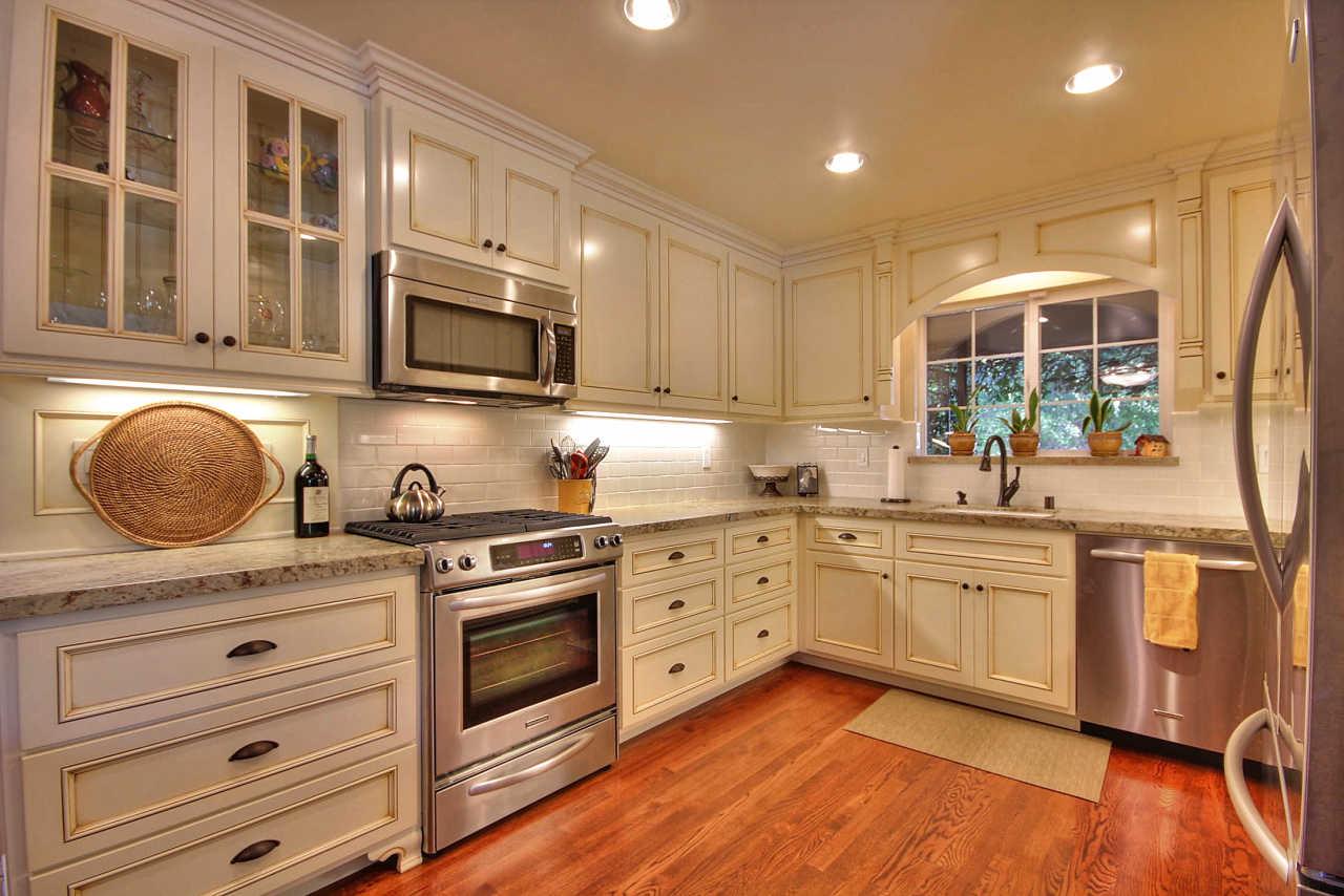 a kitchen with stainless steel appliances granite countertop a stove and cabinets