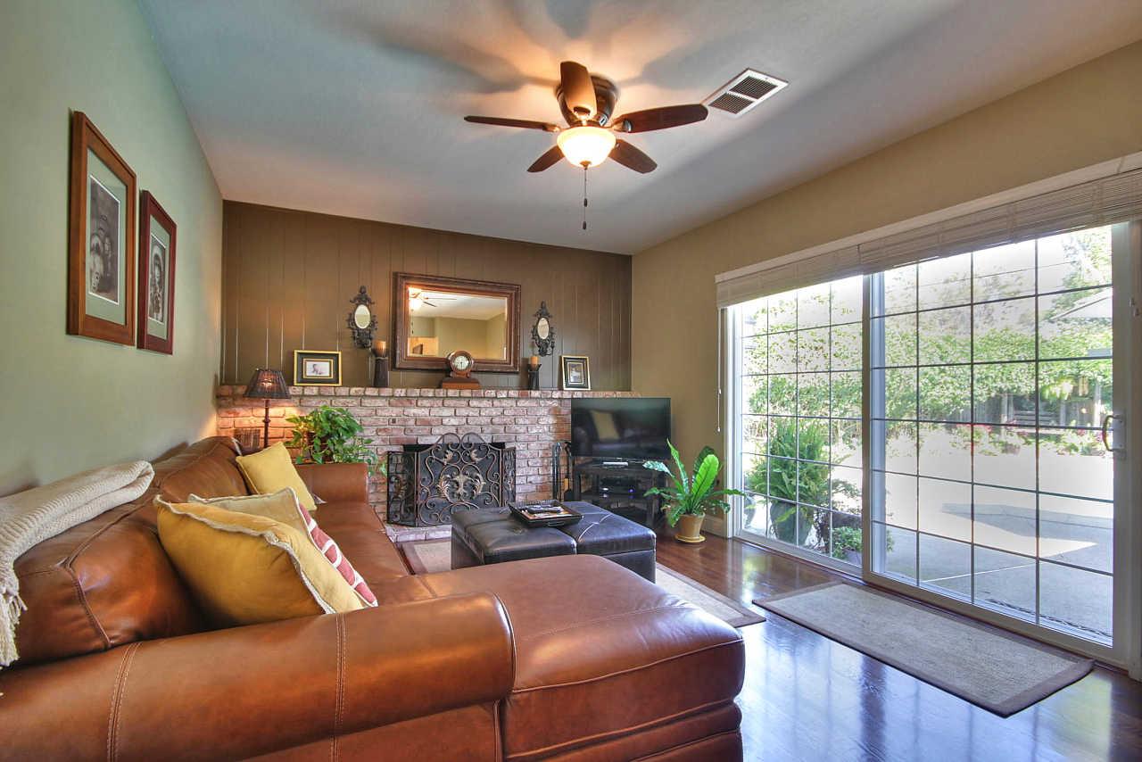 3953 Bucknall Road Campbell, CA 95008 - Photo 12 of 30 a living room with furniture a fireplace and a large window