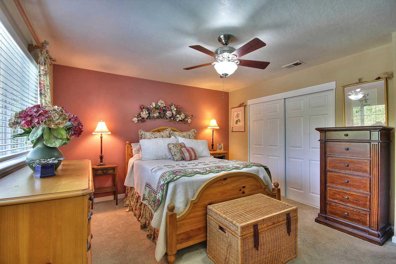 3953 Bucknall Road Campbell, CA 95008 - Photo 22 of 30 a bedroom with a bed and a chandelier