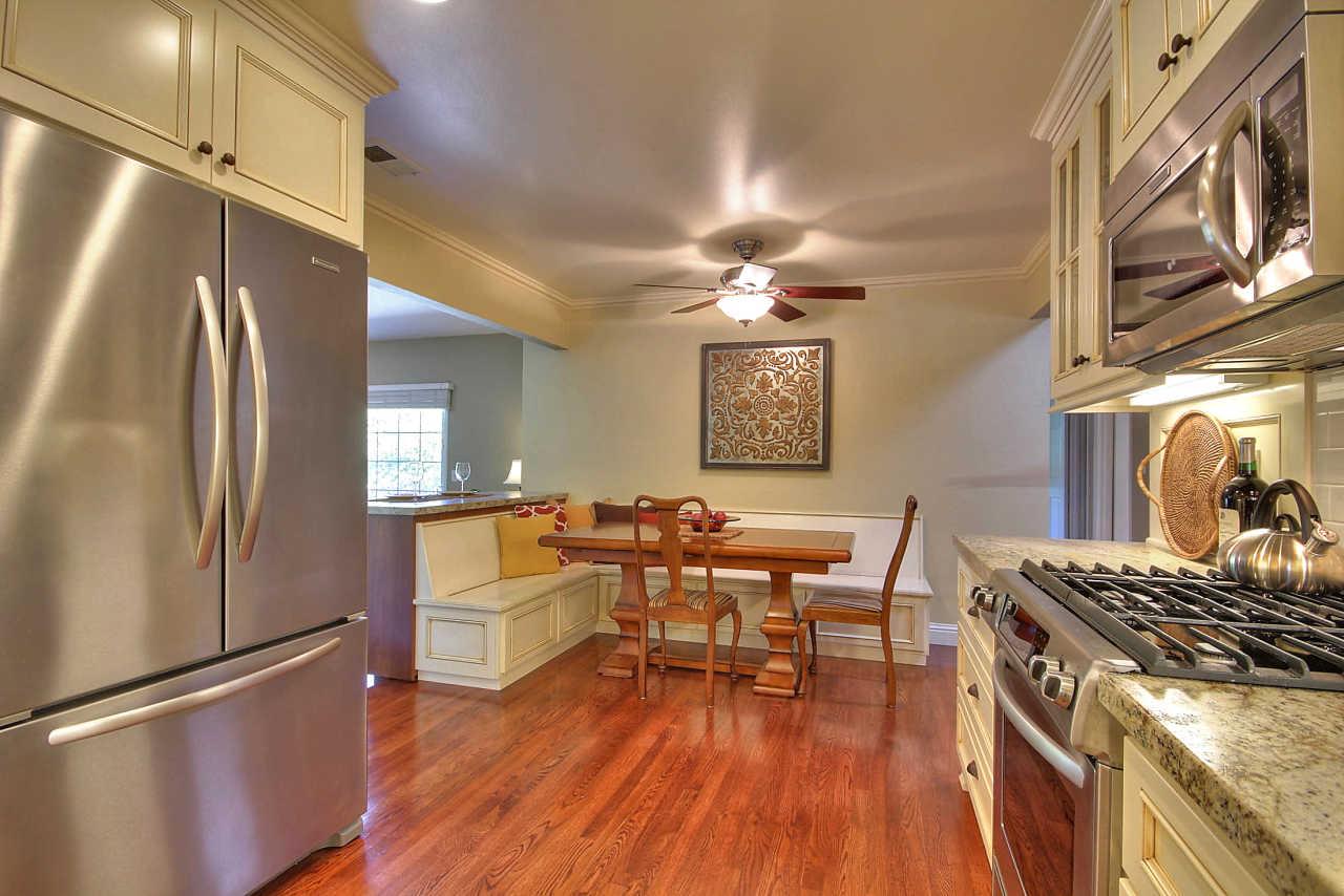 3953 Bucknall Road Campbell, CA 95008 - Photo 7 of 30 a kitchen with stainless steel appliances granite countertop a refrigerator a stove top oven a dining table and chairs with wooden floor