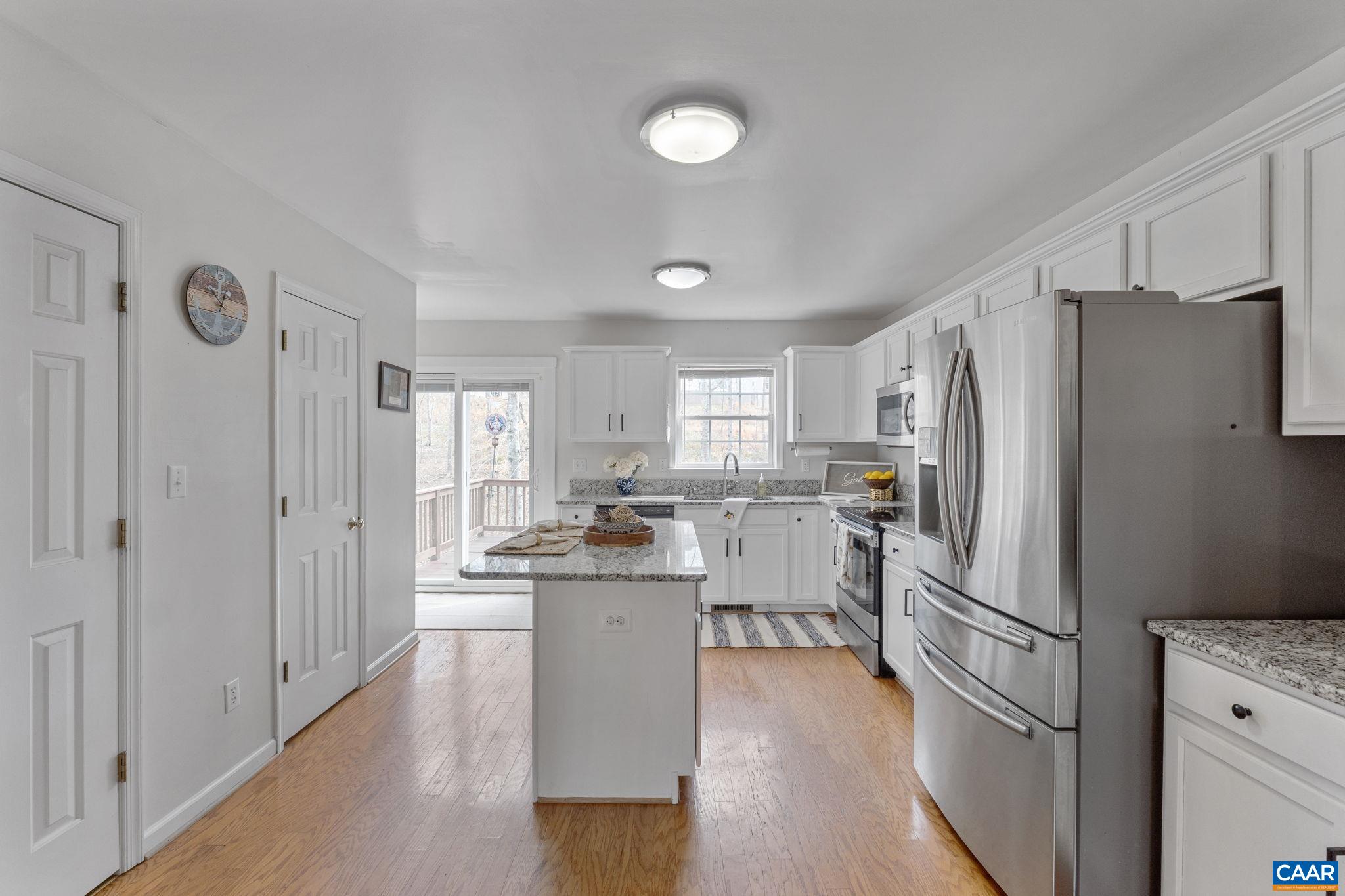 89 Riverside Drive Palmyra, VA 22963 - Photo 11 of 38 a kitchen with white cabinets and stainless steel appliances