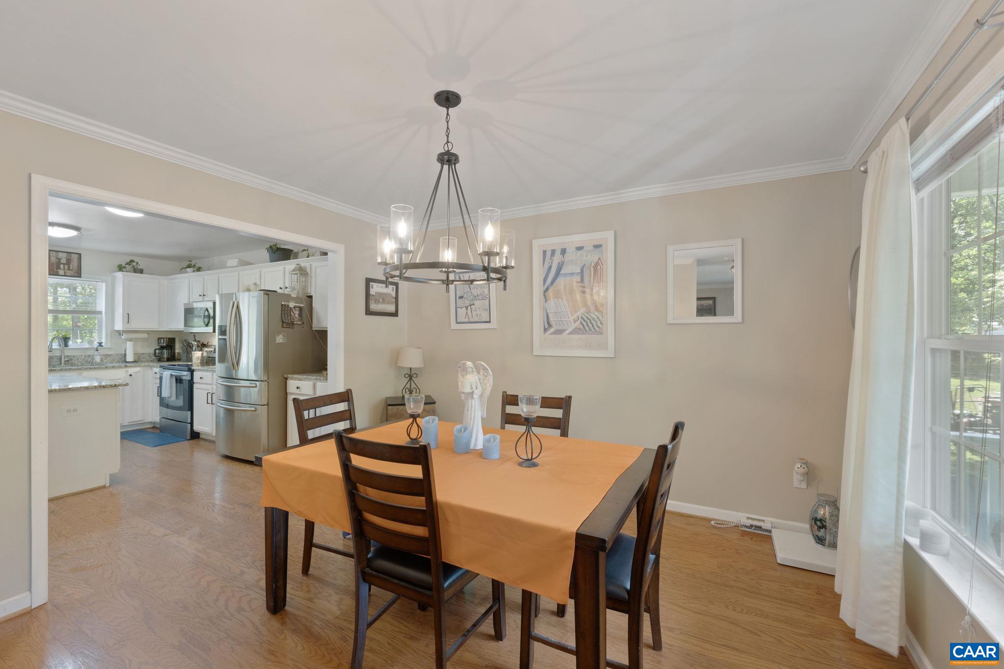 89 Riverside Drive Palmyra, VA 22963 - Photo 11 of 47 a view of a dining room with furniture a chandelier and wooden floor