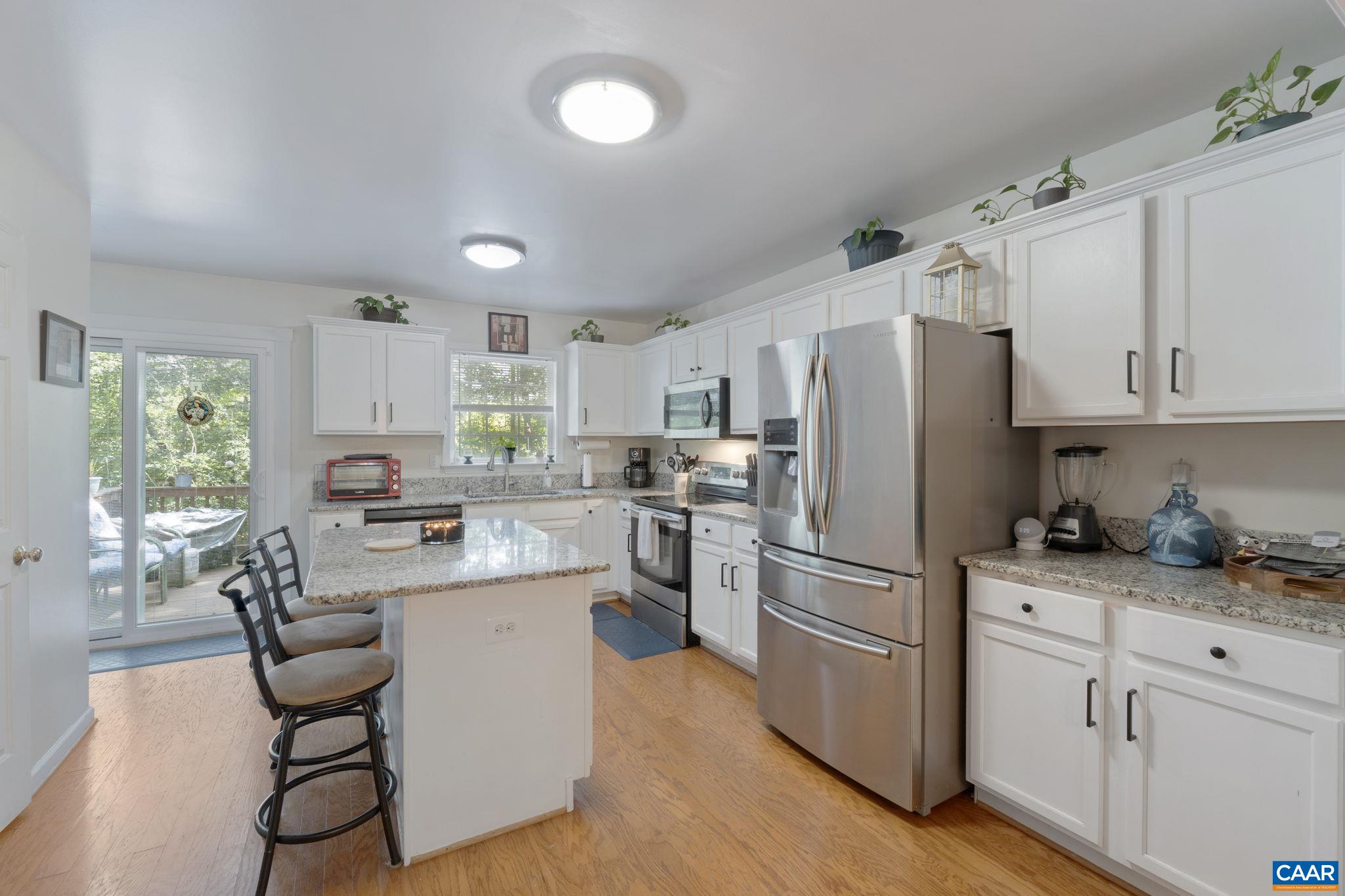 89 Riverside Drive Palmyra, VA 22963 - Photo 12 of 47 a kitchen with white cabinets and stainless steel appliances