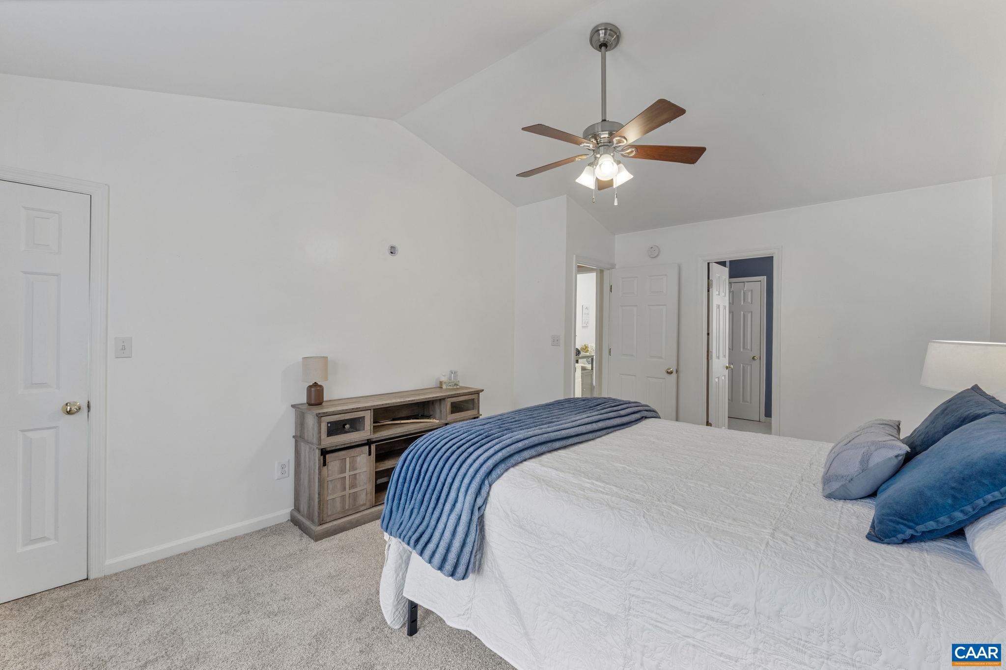 89 Riverside Drive Palmyra, VA 22963 - Photo 14 of 38 a bedroom with a bed and a chandelier