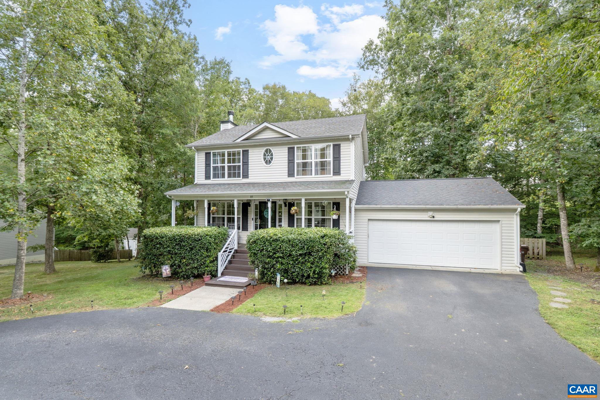 89 Riverside Drive Palmyra, VA 22963 - Photo 2 of 47 a front view of a house with a yard and garage