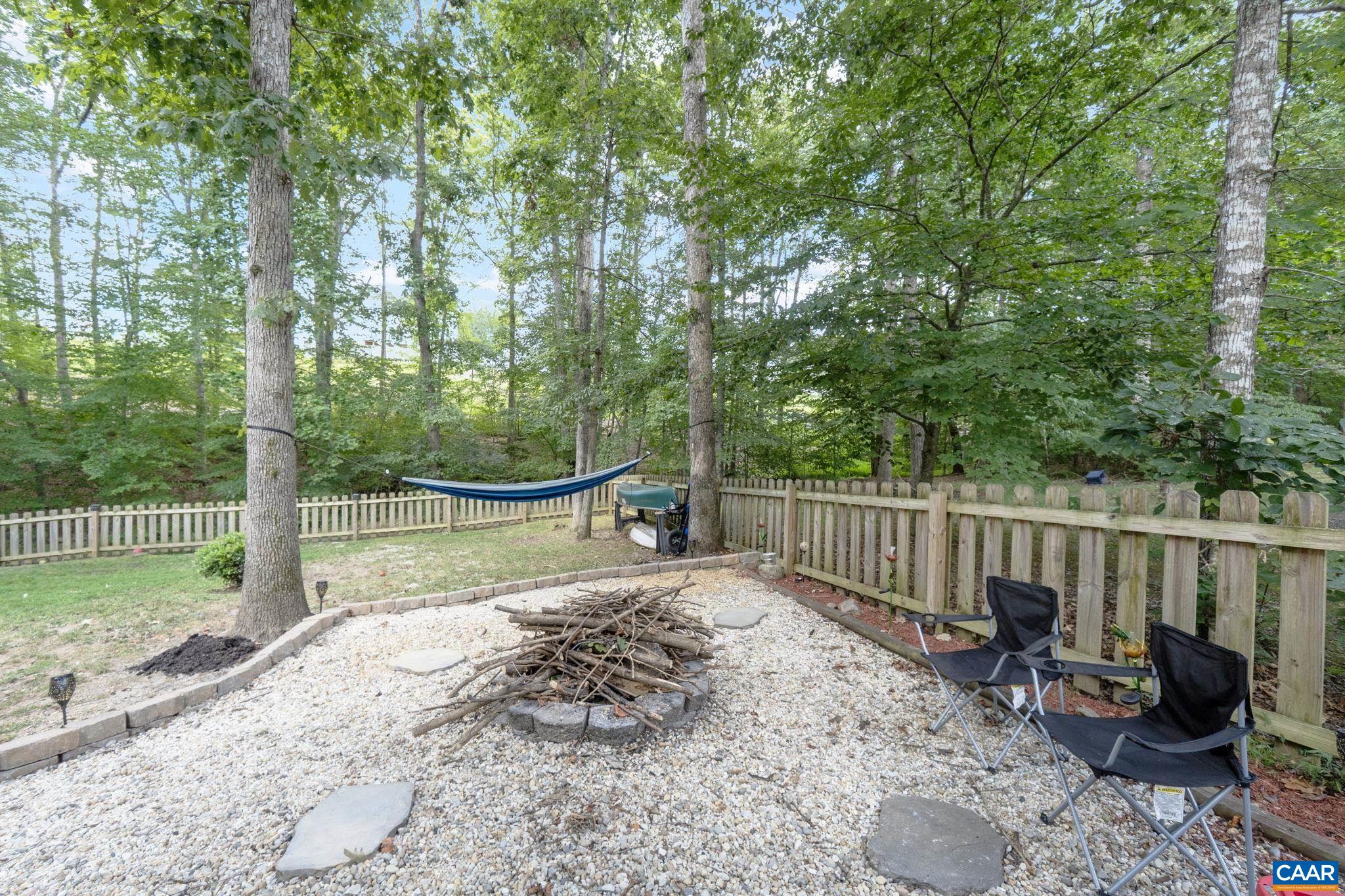 89 Riverside Drive Palmyra, VA 22963 - Photo 28 of 38 a view of a backyard with large trees and wooden fence
