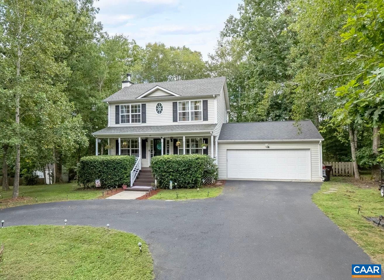 89 Riverside Drive Palmyra, VA 22963 - Photo 4 of 38 a front view of a house with a yard and trees