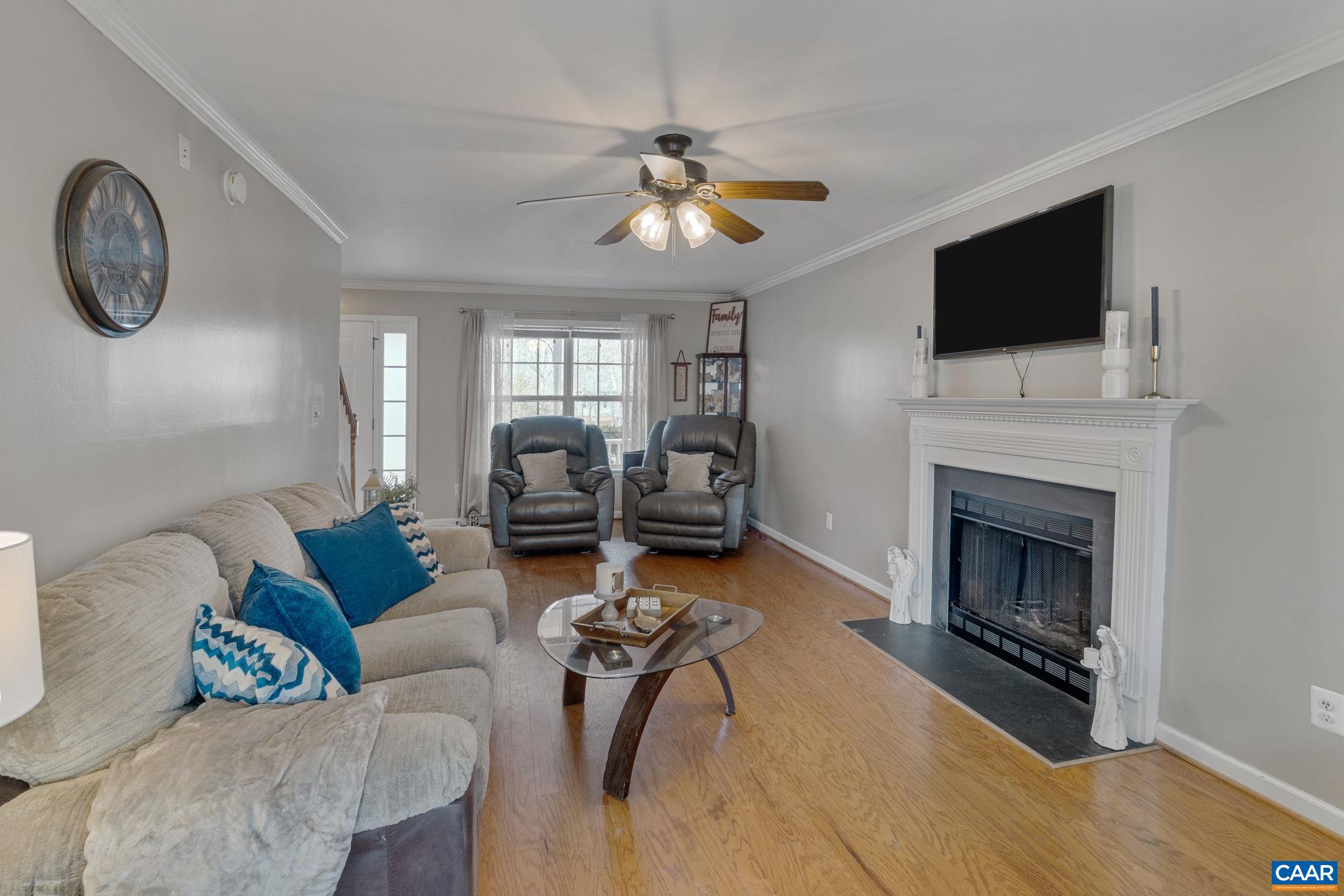 89 Riverside Drive Palmyra, VA 22963 - Photo 7 of 38 a living room with furniture a fireplace and a flat screen tv