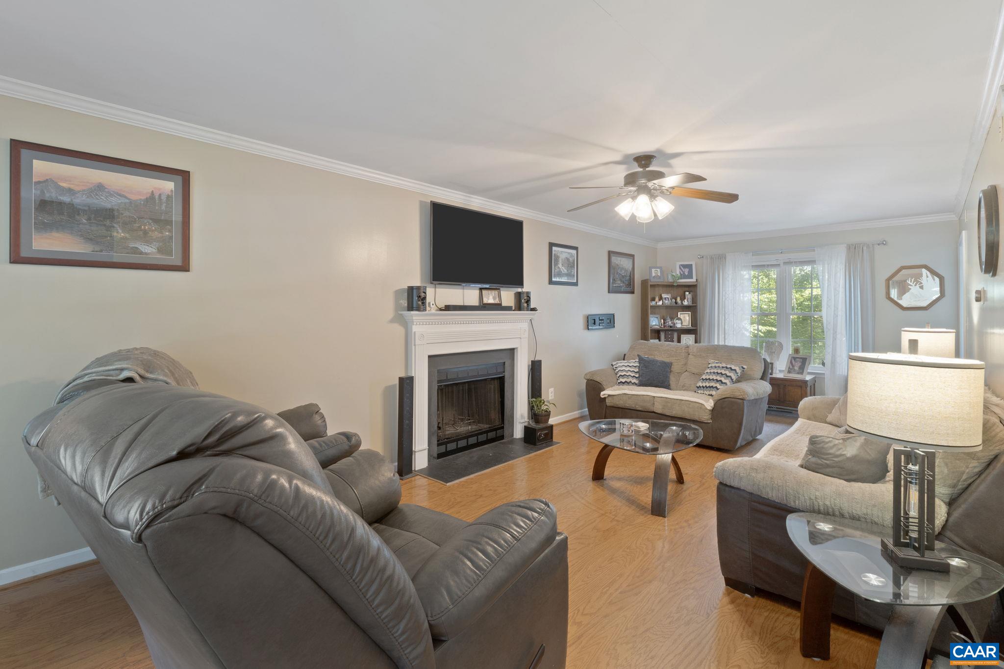 89 Riverside Drive Palmyra, VA 22963 - Photo 9 of 47 a living room with furniture a fireplace and a flat screen tv
