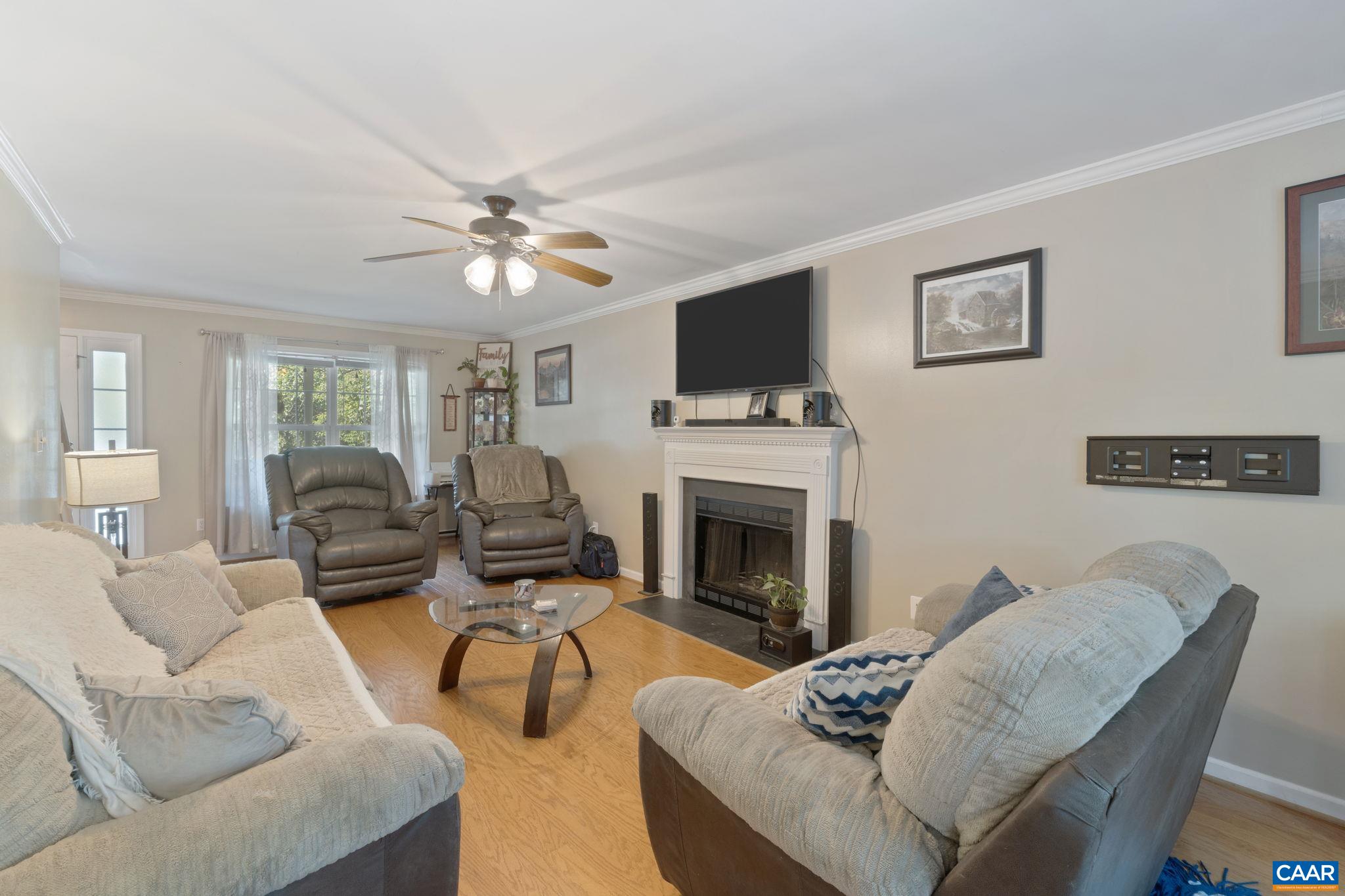 89 Riverside Drive Palmyra, VA 22963 - Photo 10 of 47 a living room with furniture a flat screen tv and a fireplace