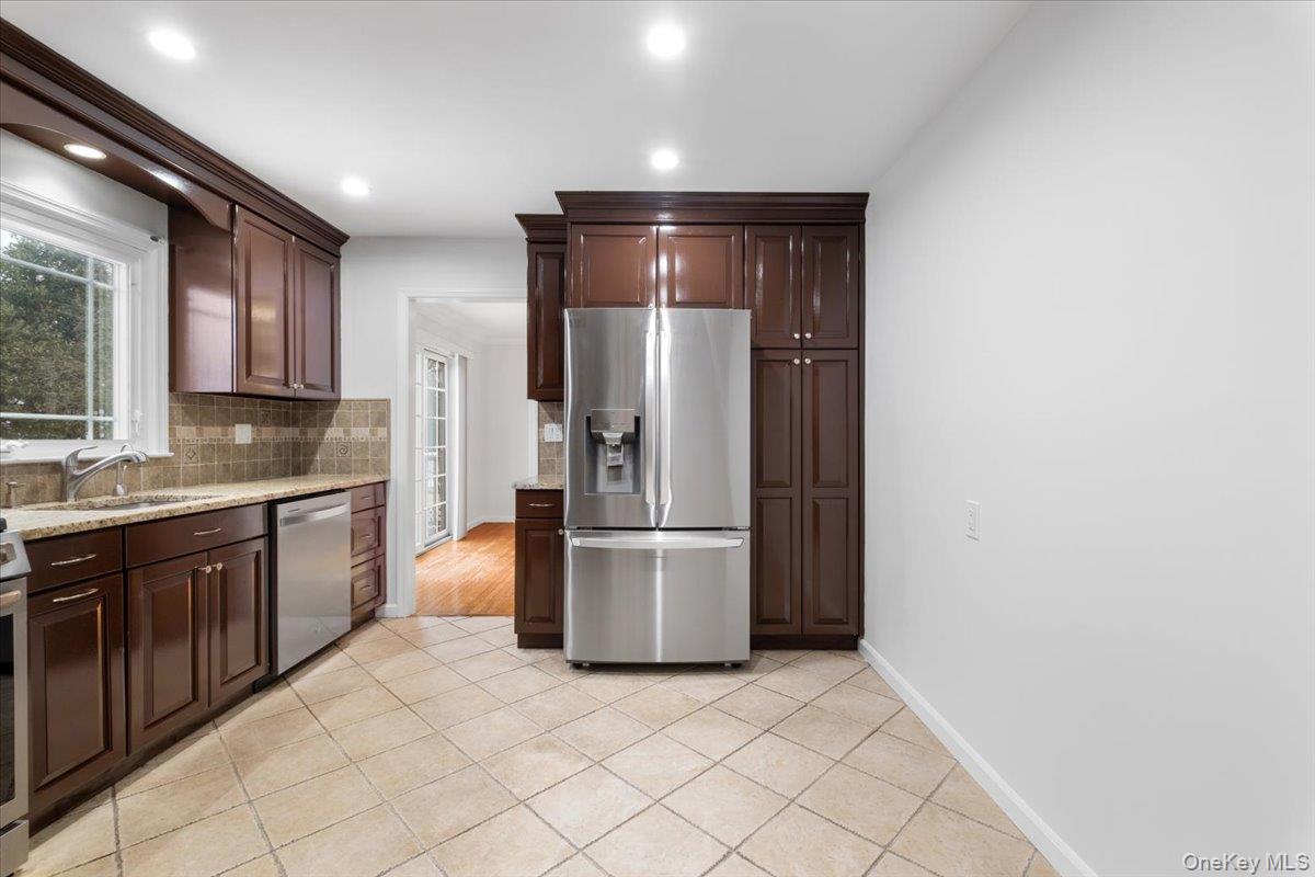 182 Madison Road Scarsdale, NY 10583 - Photo 14 of 30 a kitchen with a refrigerator and a sink