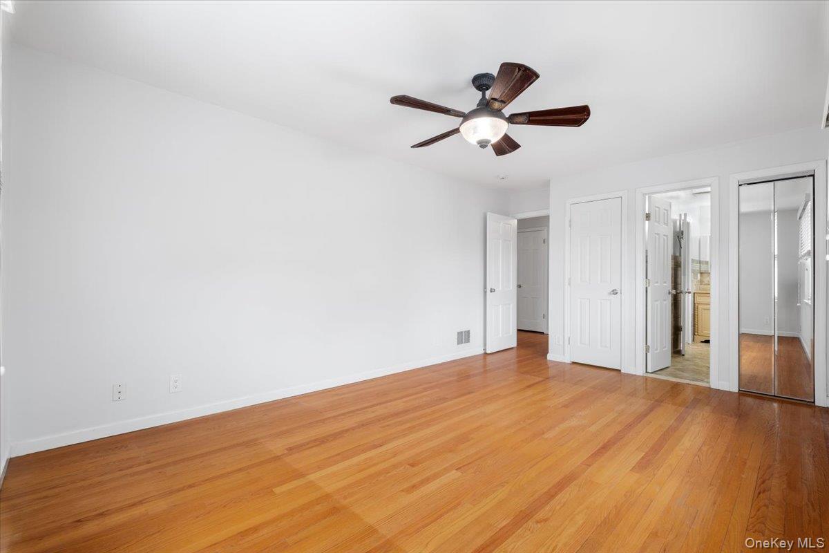 182 Madison Road Scarsdale, NY 10583 - Photo 17 of 30 a view of empty room with wooden floor and ceiling fan