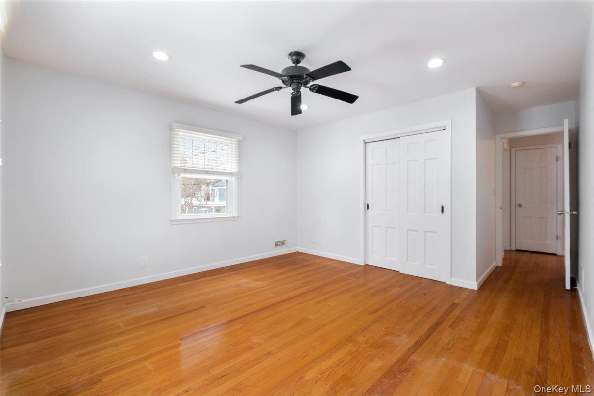 182 Madison Road Scarsdale, NY 10583 - Photo 19 of 30 a view of empty room with wooden floor and ceiling fan