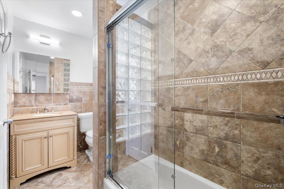 182 Madison Road Scarsdale, NY 10583 - Photo 22 of 30 a bathroom with a granite countertop sink a toilet and shower