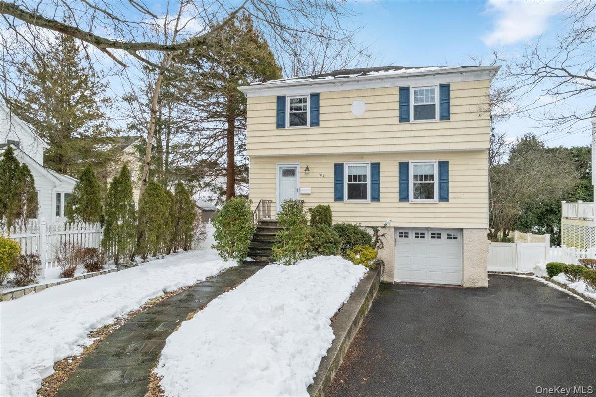182 Madison Road Scarsdale, NY 10583 - Photo 25 of 30 a view of a house with a yard covered in snow
