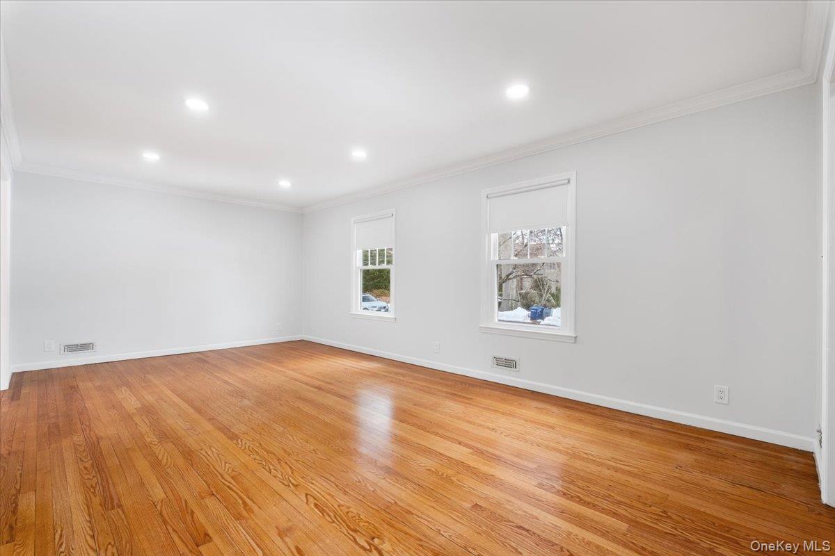 182 Madison Road Scarsdale, NY 10583 - Photo 6 of 30 an empty room with wooden floor and windows
