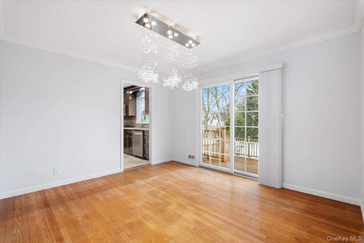 182 Madison Road Scarsdale, NY 10583 - Photo 9 of 30 a view of an empty room with wooden floor and a window