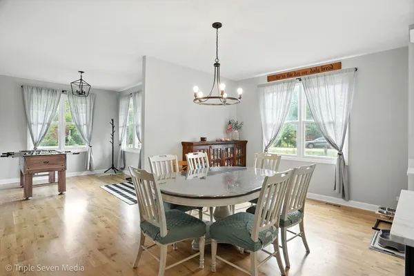 a view of a dining room with furniture window and wooden floor