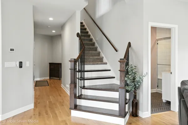 a view of entryway and hall with wooden floor
