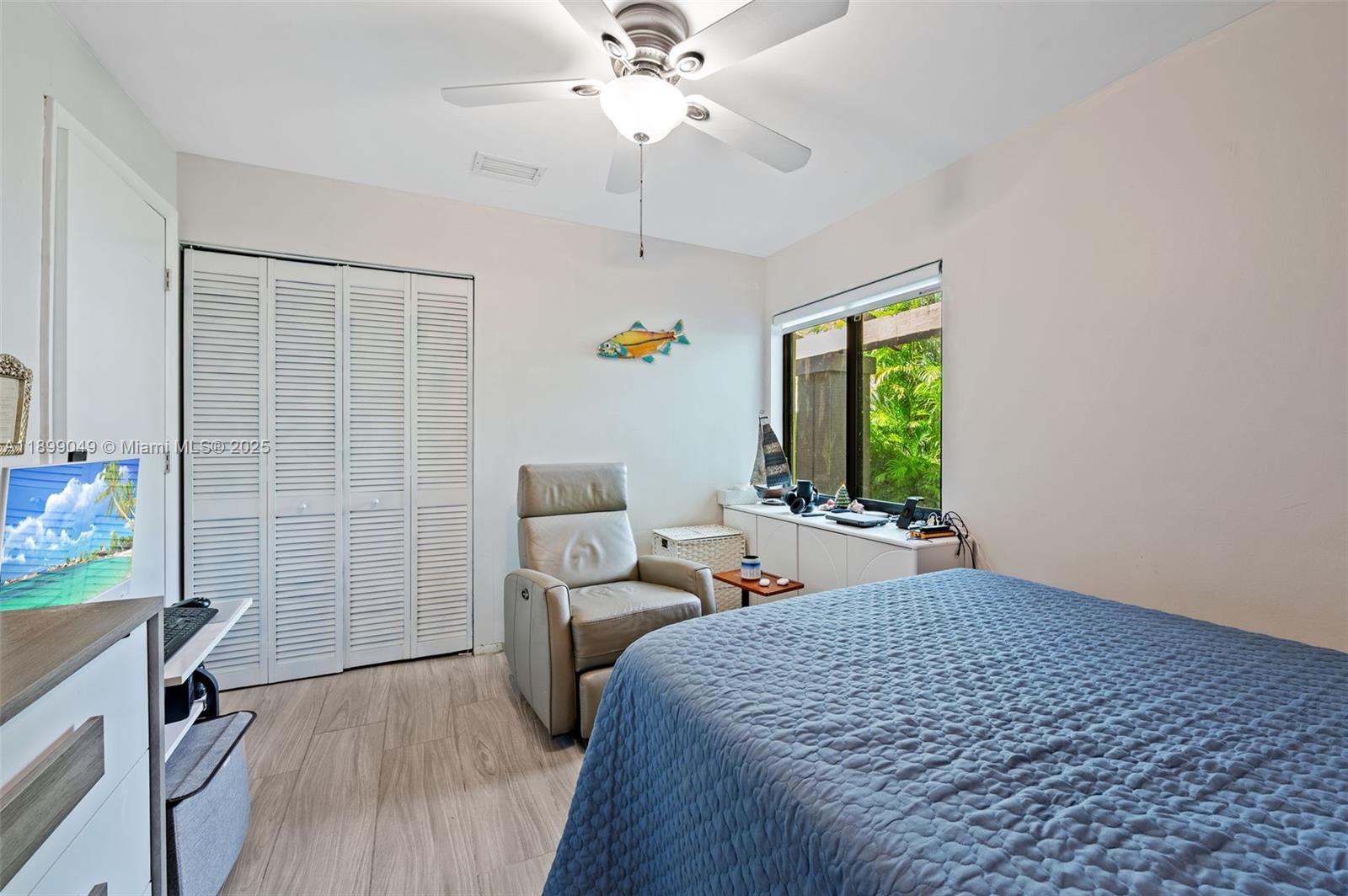 10923 Southwest 134th Court Miami, FL 33186 - Photo 15 of 28 a bedroom with a bed and a chandelier