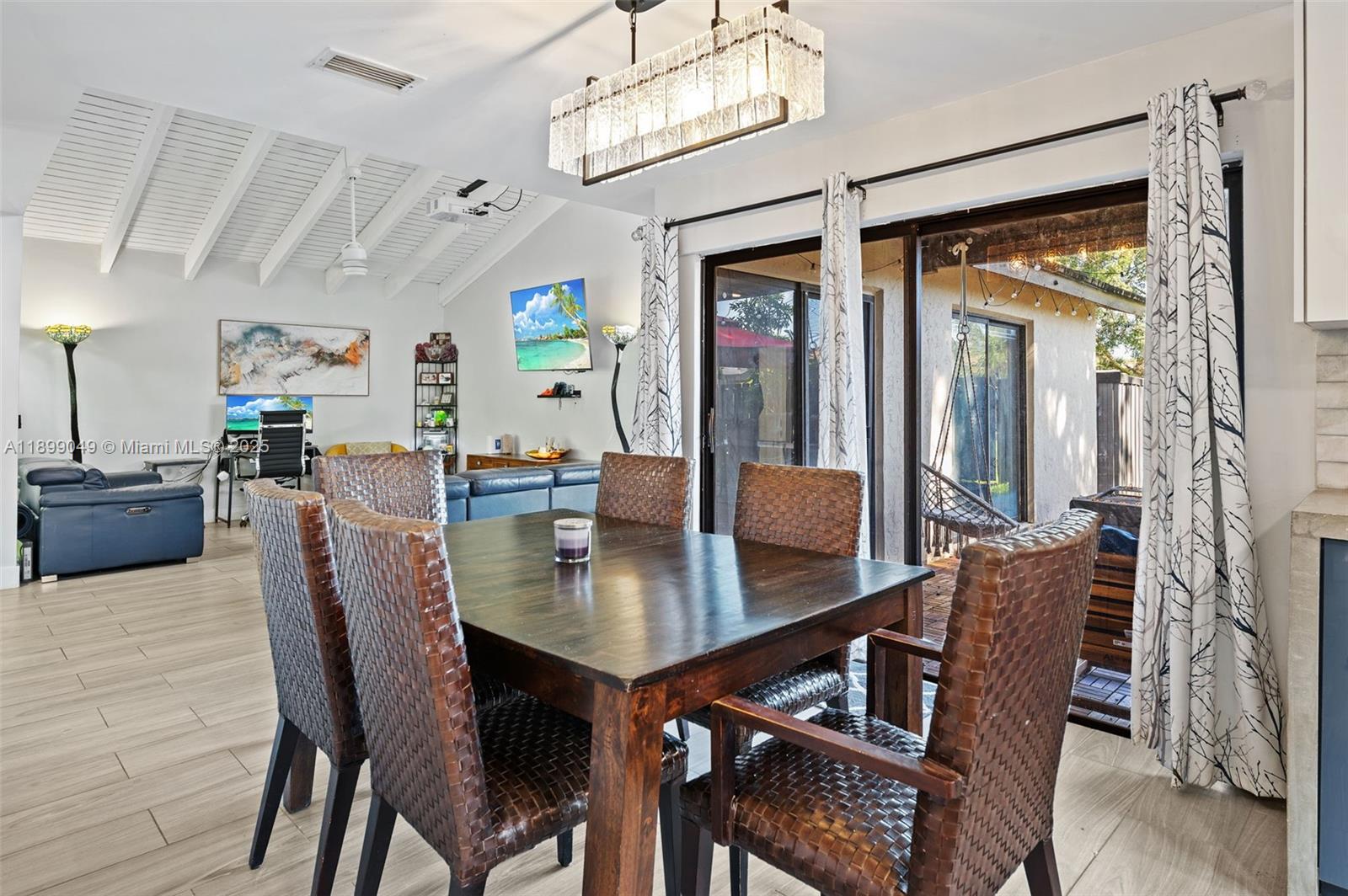 10923 Southwest 134th Court Miami, FL 33186 - Photo 9 of 28 a view of a dining room with furniture and a chandelier