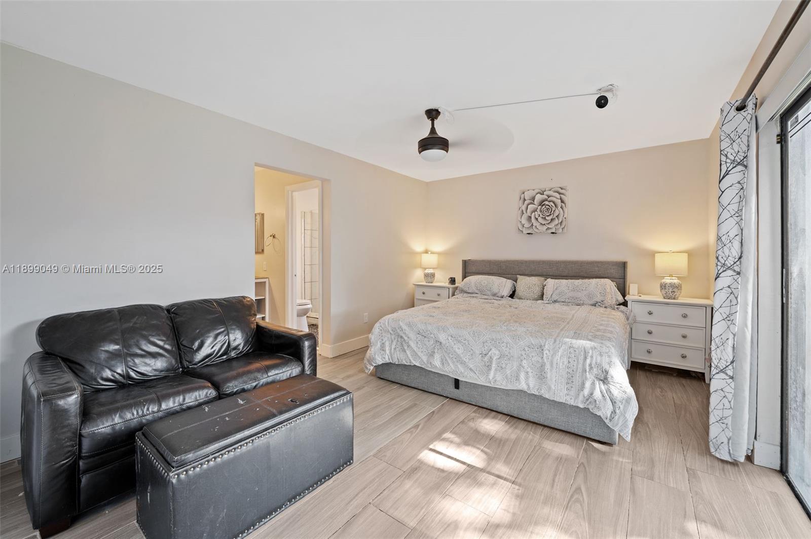 10923 Southwest 134th Court Miami, FL 33186 - Photo 10 of 28 a bedroom with a bed couch and a window