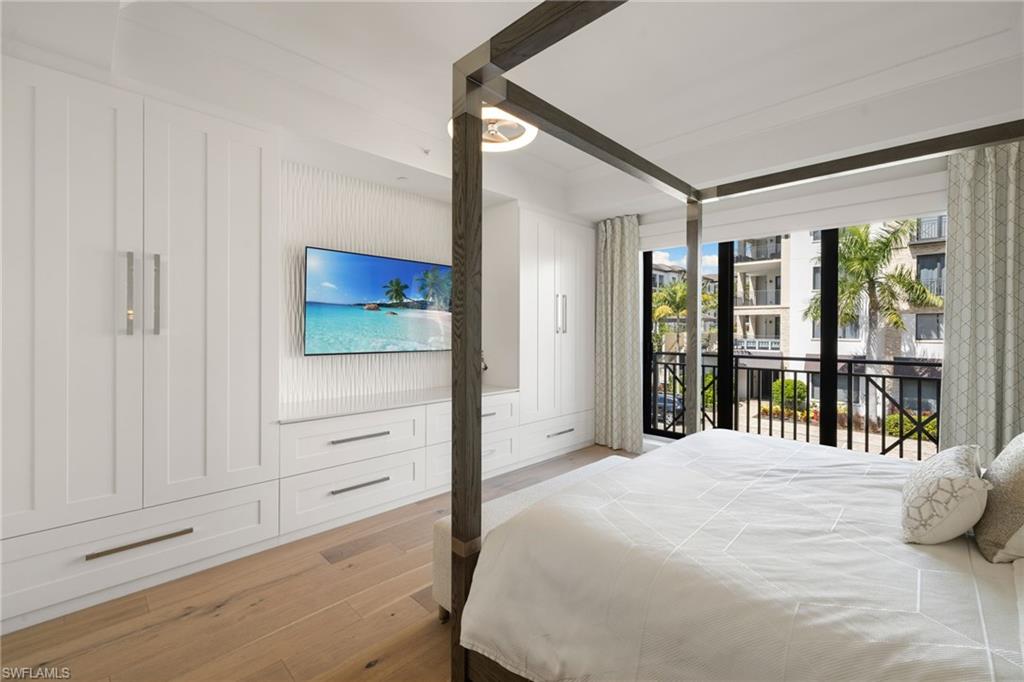 1130 3rd Avenue South, Unit 210 Naples, FL 34102 - Photo 18 of 48 a bedroom with a bed and a large window