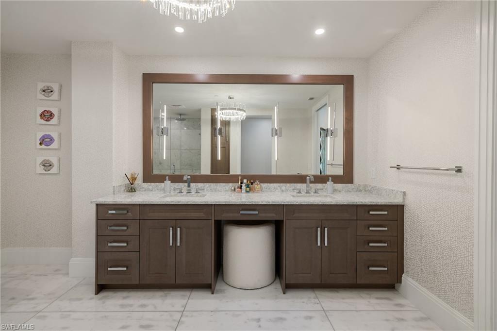 1130 3rd Avenue South, Unit 210 Naples, FL 34102 - Photo 20 of 48 a bathroom with a granite countertop sink a large mirror and a