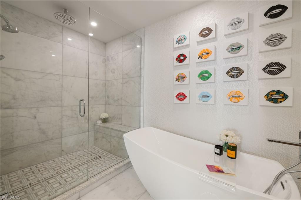 1130 3rd Avenue South, Unit 210 Naples, FL 34102 - Photo 21 of 48 a bathroom with a bathtub and a shower