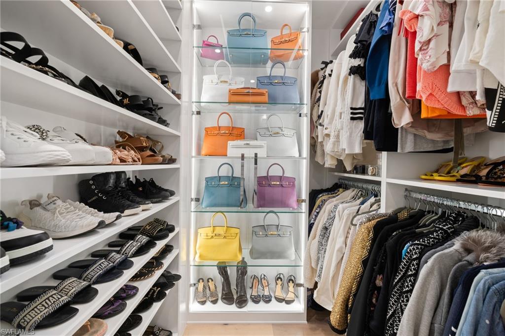 1130 3rd Avenue South, Unit 210 Naples, FL 34102 - Photo 23 of 48 a view of walk in closet with clothes and shoes