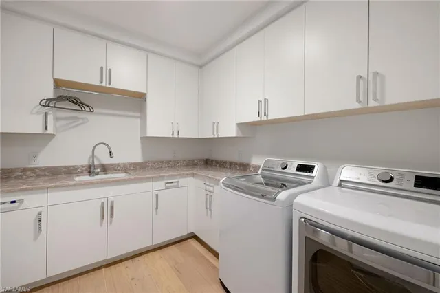 a kitchen with granite countertop a sink a stove and cabinets