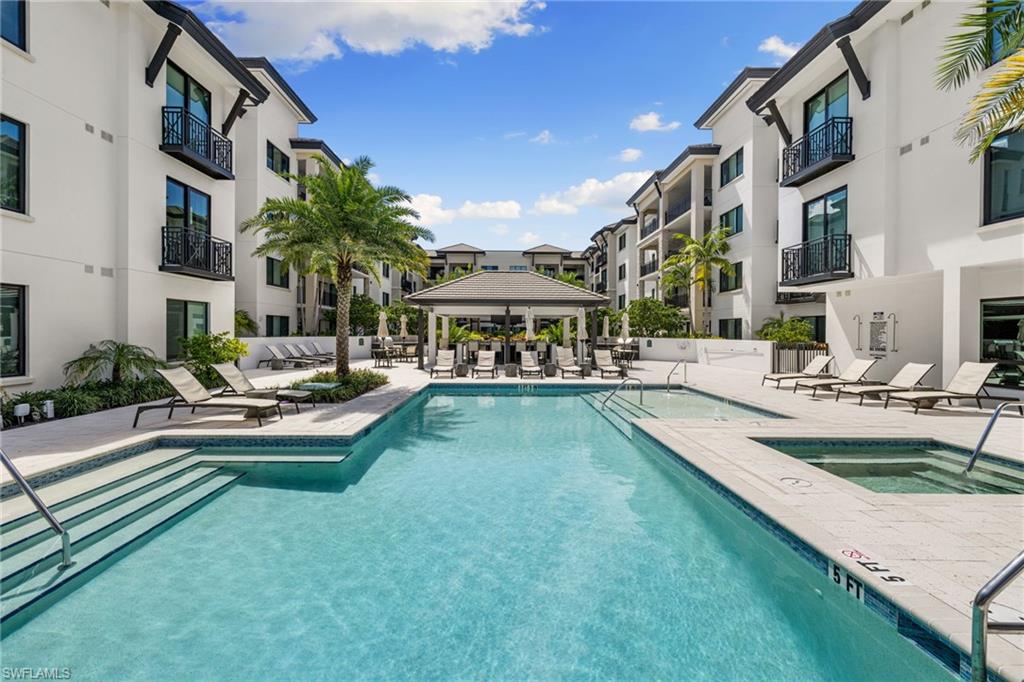 1130 3rd Avenue South, Unit 210 Naples, FL 34102 - Photo 38 of 48 a view of a house with swimming pool and sitting area