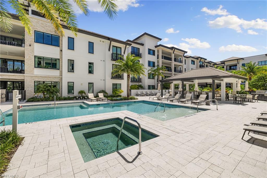 1130 3rd Avenue South, Unit 210 Naples, FL 34102 - Photo 39 of 48 a swimming pool with outdoor seating and yard