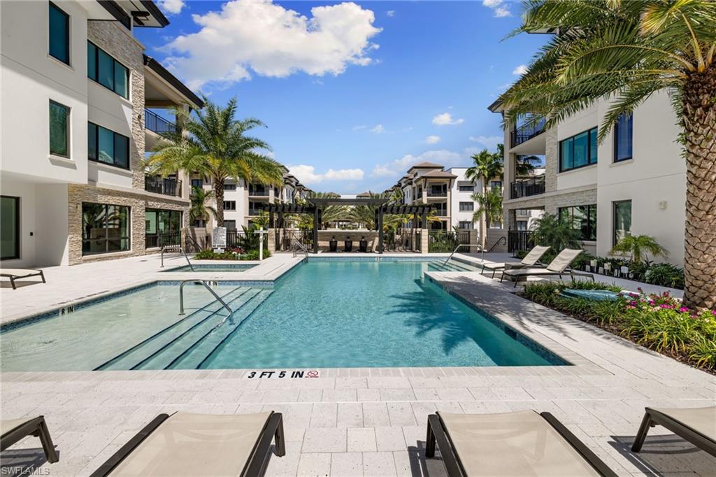 1130 3rd Avenue South, Unit 210 Naples, FL 34102 - Photo 40 of 48 a view of a patio with table and chairs and potted plants