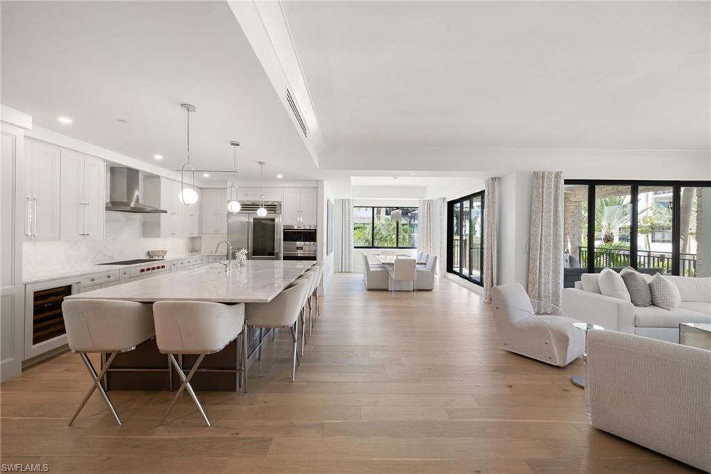 1130 3rd Avenue South, Unit 210 Naples, FL 34102 - Photo 4 of 48 a dining room with furniture and a view of kitchen