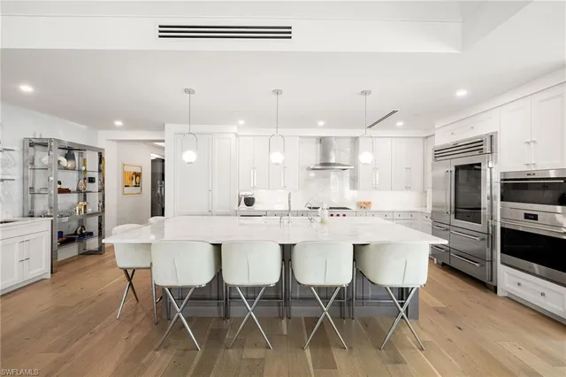 a large kitchen with a table and chairs